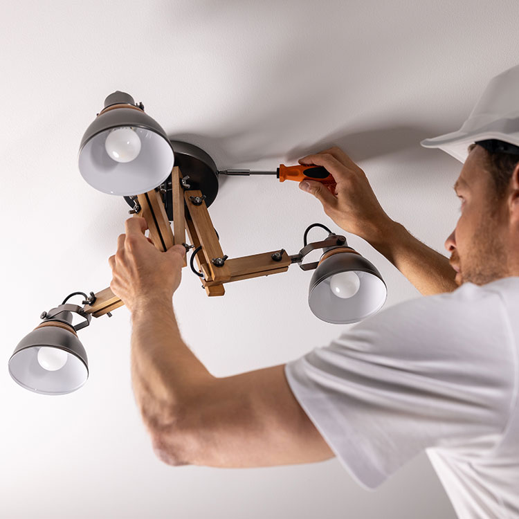 Picture of a handyman installing a light.